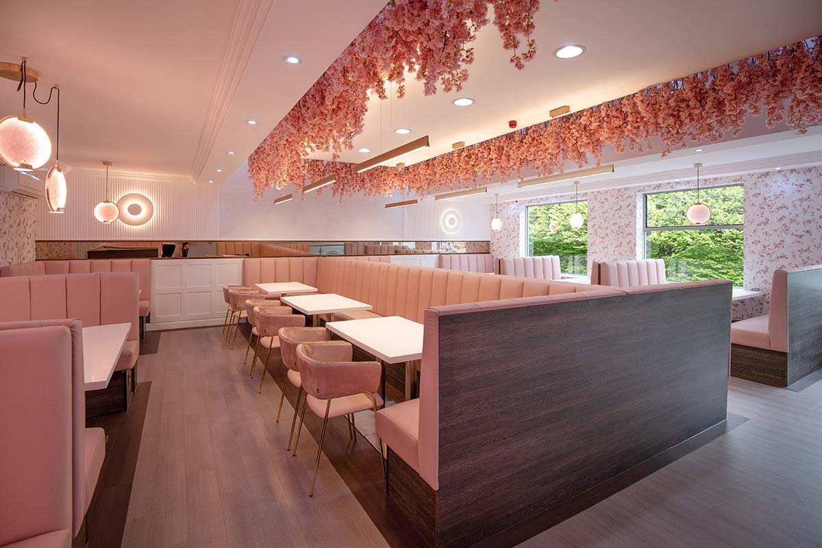 Pink walls and neon lettering for a Bollywood-style restaurant bar 
